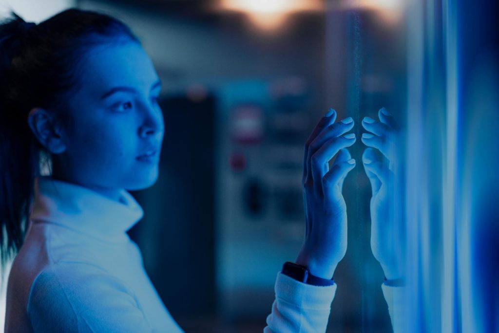 A woman engineer touching a blue screen